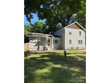 Charming home featuring a well-manicured lawn and a classic facade, blending traditional aesthetics with modern comfort at 5421 Princess St, Charlotte, NC 28269