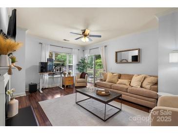 Inviting living room featuring a comfortable sofa, stylish coffee table and large windows for natural light at 5730 Closeburn Rd # H, Charlotte, NC 28210