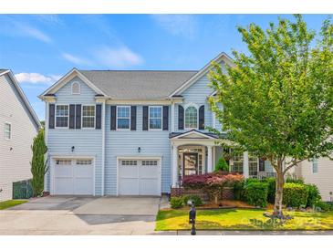 Charming two-story home with a well-manicured lawn, two-car garage, and inviting curb appeal at 6424 Chadwell Ct, Fort Mill, SC 29707
