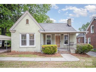 Charming one story home featuring a brick facade, covered porch, and well-maintained landscaping at 813 S Ridge Ave, Kannapolis, NC 28083