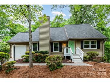 Charming single-story home featuring manicured landscaping, a quaint entrance, and a light-colored exterior at 11102 Sundown Ln, Charlotte, NC 28226