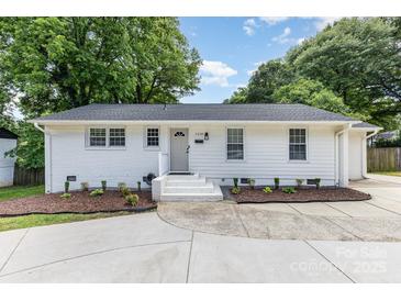 Charming single-story home featuring a freshly painted exterior, tidy landscaping and a newly updated driveway at 1218 E Woodlawn Rd, Charlotte, NC 28209