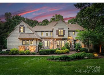 Charming stone and wood home featuring mature landscaping and beautiful architectural details at 12835 Ninebark Trl, Charlotte, NC 28278