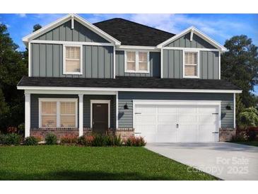 Charming two-story home featuring vertical siding, multiple windows, a two-car garage, and a well-maintained lawn at 2149 Sunflower Cir, Newton, NC 28658