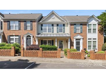 Charming townhome with brick facade, manicured landscaping, and inviting front porch at 4100 B Christine Ln, Waxhaw, NC 28173