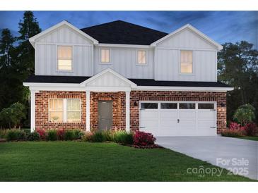 Beautiful two-story home with brick and white siding, a two-car garage, and well-maintained landscaping at 426 Bent Burr Crk, York, SC 29745
