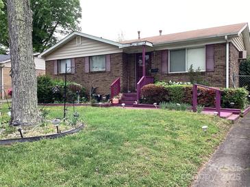 Charming single-story brick home with a well-maintained lawn and vibrant landscaping in the front yard at 4729 Monmouth Dr, Charlotte, NC 28269
