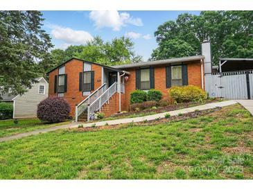 Charming brick home with a well-manicured lawn and inviting stairway entrance at 6221 Thermal Rd, Charlotte, NC 28211