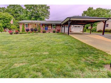 Beautiful brick home with well-manicured lawn, carport, and a charming blue front door at 800 Sunset Rd, Cherryville, NC 28021