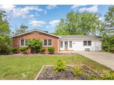 Charming single-story home featuring a brick facade, white siding, and a well-manicured front yard at 830 Cabaniss Dr, Shelby, NC 28150