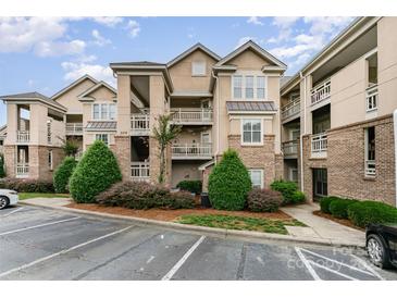 Well-maintained condo building with manicured landscaping and ample parking at 104 Pier 33 Dr # 311, Mooresville, NC 28117