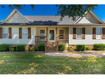 Charming single story home with covered front porch and meticulously maintained landscaping at 1560 Springlake Rd, York, SC 29745