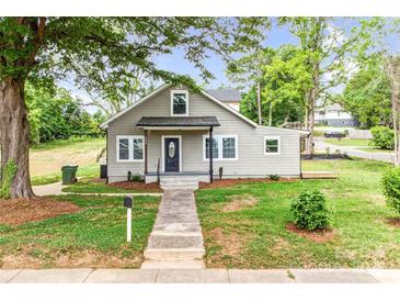 Charming bungalow-style home with a well-manicured lawn and inviting front porch at 225 N Lee St, Mount Holly, NC 28120