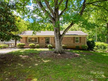 Charming brick home featuring a well-maintained lawn and mature trees in a serene setting at 2808 Findley Rd, Statesville, NC 28625