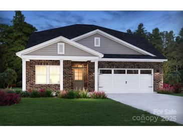 Charming brick home with a two-car garage, manicured lawn, and inviting front porch at 432 Bent Burr Crk, York, SC 29745