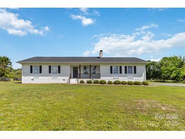 Charming single-story brick home featuring manicured lawn and inviting front porch at 4855 Saluda Rd, Rock Hill, SC 29730