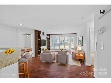 Bright living room features hardwood floors, large windows, and modern decor at 513 N Graham St # 1B, Charlotte, NC 28202