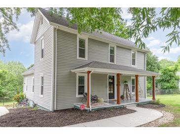 Charming two-story home boasts a welcoming front porch, landscaped yard, and classic architectural details at 702 S Government St, Lincolnton, NC 28092