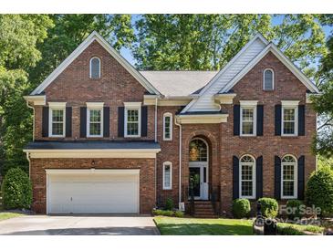 Beautiful two-story brick home with attached two-car garage and mature landscaping at 909 Staghorn Ln, Waxhaw, NC 28173