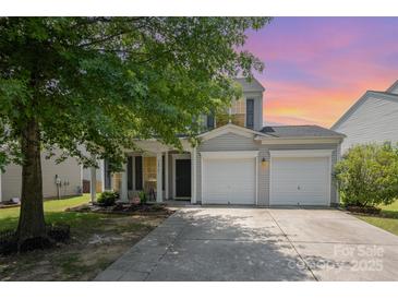 Charming two-story home boasts a well-manicured lawn and two-car garage at 10901 Claude Freeman Dr, Charlotte, NC 28262