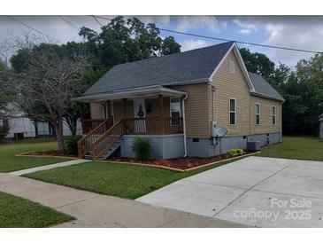 Charming home featuring a welcoming front porch and well-maintained lawn at 615 Grier St, Lincolnton, NC 28092