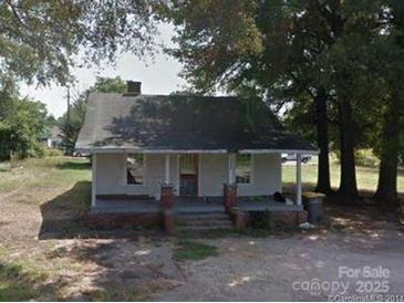 Charming home with a covered front porch, brick detail, and mature trees at 1105 Horton Ave, Kannapolis, NC 28083