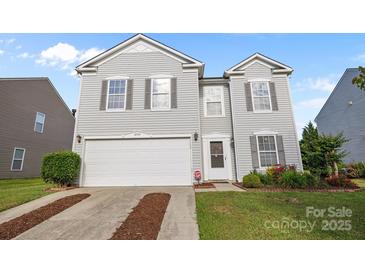 Charming two-story home with gray siding, manicured lawn, and attached two-car garage at 12724 Frank Wiley Ln, Charlotte, NC 28278
