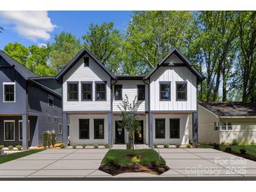 Stunning new construction exterior featuring a modern design and inviting front yard at 2006 St John St, Charlotte, NC 28216