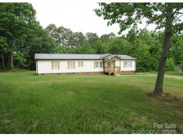 Charming single-story home with a well-maintained lawn and metal roof at 3315 Buffalo Shoals Rd, Newton, NC 28658