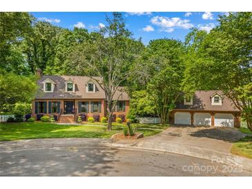 Charming two-story brick home with lush landscaping and a three-car garage in a desirable neighborhood at 341 N Mulberry St, Statesville, NC 28677