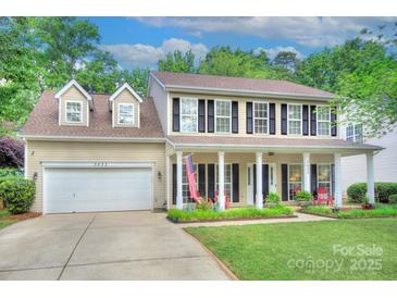 Charming two-story home featuring a welcoming front porch and well-maintained landscaping at 3632 Cole Mill Rd, Charlotte, NC 28270