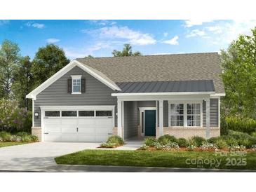 Charming one-story home with a two-car garage, well-manicured lawn, and classic architectural details at 527 Sunharvest Ln, Indian Trail, NC 28079
