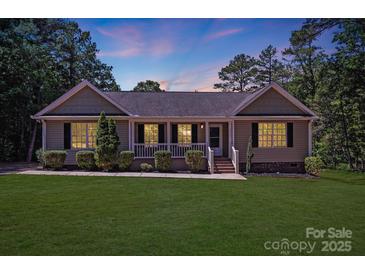 Charming single-story home featuring a well-manicured lawn and inviting front porch at 5564 N Hillsdale Dr, Fort Lawn, SC 29714