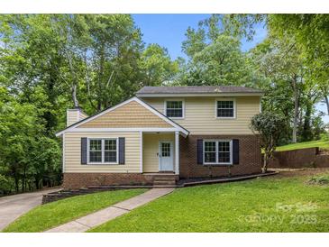 Charming two-story home features a brick foundation, inviting entrance, and lush, mature landscaping at 6713 William Harry Ct, Charlotte, NC 28211