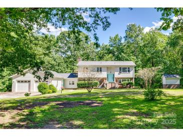 Charming two-story home with a well-maintained lawn and mature trees providing ample shade and privacy at 679 Fairforest Rd, Chester, SC 29706