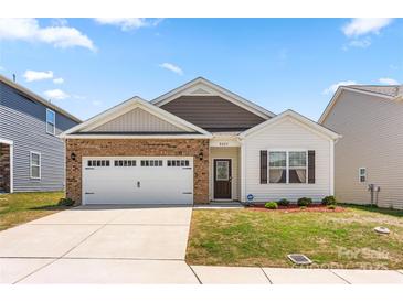 Charming single-Gathering home with a two-car garage, brick accents, and a well-manicured lawn at 9037 Remnick Dr, Gastonia, NC 28056