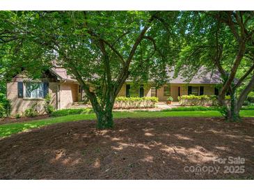 Charming brick home with mature landscaping and a welcoming entrance at 104 Ridge Dr, Stanley, NC 28164