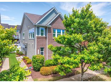 Beautiful two-story home with brick and vinyl siding, lush landscaping, and a well-maintained lawn at 17913 Ragtop Day Ln, Cornelius, NC 28031
