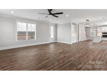 Spacious living room with luxury vinyl plank flooring, white walls, and large window at 1852 Yardley St, Rock Hill, SC 29732
