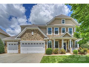 Charming two-story home boasts stone accents, a three-car garage, and lush landscaping at 3029 Allendale Dr, Fort Mill, SC 29707