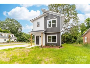 Charming two-story home with a modern gray and white exterior and newly planted landscaping at 424 Airline Ave, Shelby, NC 28150