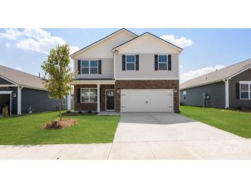 Charming two-story home with stone accents, gray siding, a well-manicured lawn, and attached two car garage at 4623 Harris Elliot Rd, Lincolnton, NC 28092