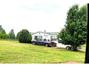 Charming single story home on a large lot featuring a lush green lawn and mature trees and a truck in the driveway at 103 Amy Dr, Kings Mountain, NC 28086