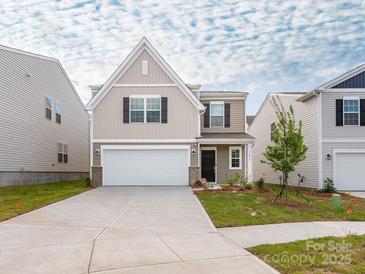 Charming two-story home with a two-car garage and a well-maintained lawn at 11019 Daisy Ct, Charlotte, NC 28262