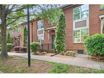 Charming red brick townhome with well-maintained landscaping, and a welcoming entrance at 119 Steinbeck Way # E, Mooresville, NC 28117