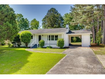 Charming white brick home with a covered carport and a well-manicured front yard at 1423 Ebinport Rd, Rock Hill, SC 29732