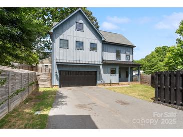 Charming two-story home featuring a modern gray exterior, a two-car garage, and a well-manicured front lawn at 1513 Landis Ave, Charlotte, NC 28205