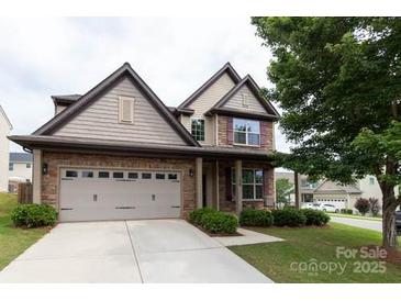 Charming two-story home featuring a brick and siding exterior, well-maintained lawn, and a two-car garage at 159 Saye Pl, Mooresville, NC 28115