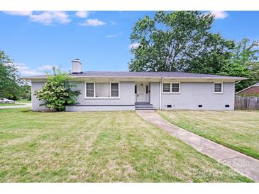 Charming single-story home featuring a brick facade, well-maintained lawn, and inviting curb appeal at 2001 Tyvola Rd, Charlotte, NC 28210