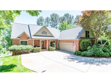 Beautiful single-Gathering home featuring a brick facade, mature landscaping, and an attached two-car garage at 2580 Penngate Dr, Sherrills Ford, NC 28673